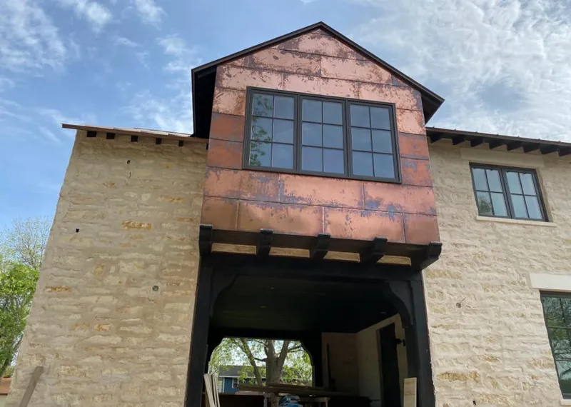 Copper metal panel facade on a stone building for Skylight Installation in Bonner Springs
